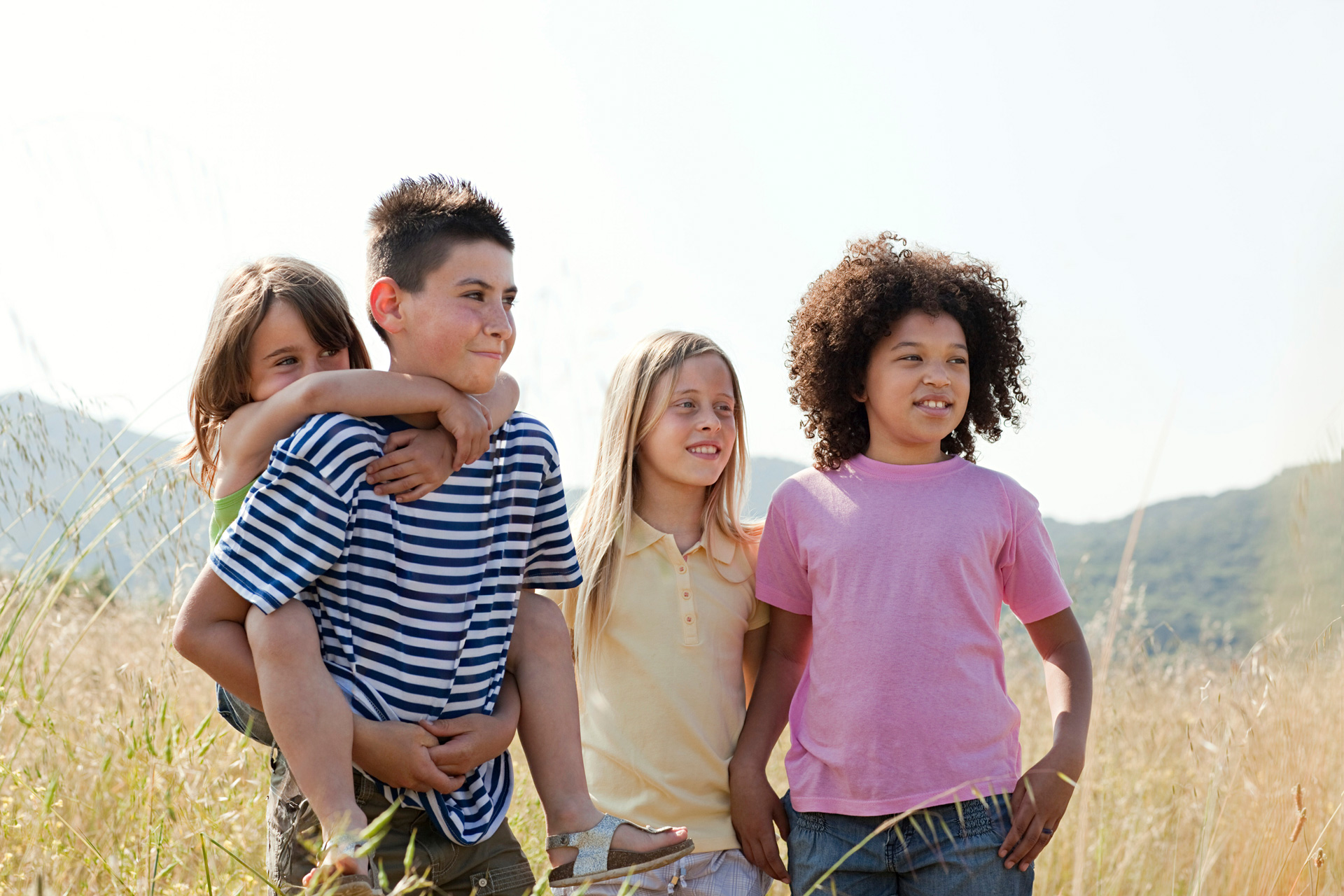 four-friends-in-field-youngest-girl-having-piggy-2025-04-04-20-29-40-utc